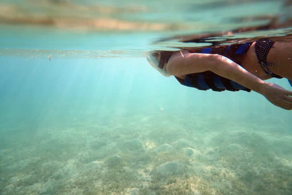 Schnorcheln ist eine Form des Schwimmens, bei der du auf oder nahe der Wasseroberfläche mit dem Kopf über Wasser schwimmst und einen Schnorchel zum Atmen benutzt.